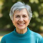 Portrait of Nancy Chen, 56-year-old woman with short gray hair and radiant smile
