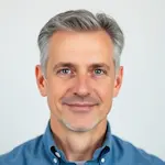 Portrait of Richard Thompson, 58-year-old businessman with salt and pepper hair and warm smile